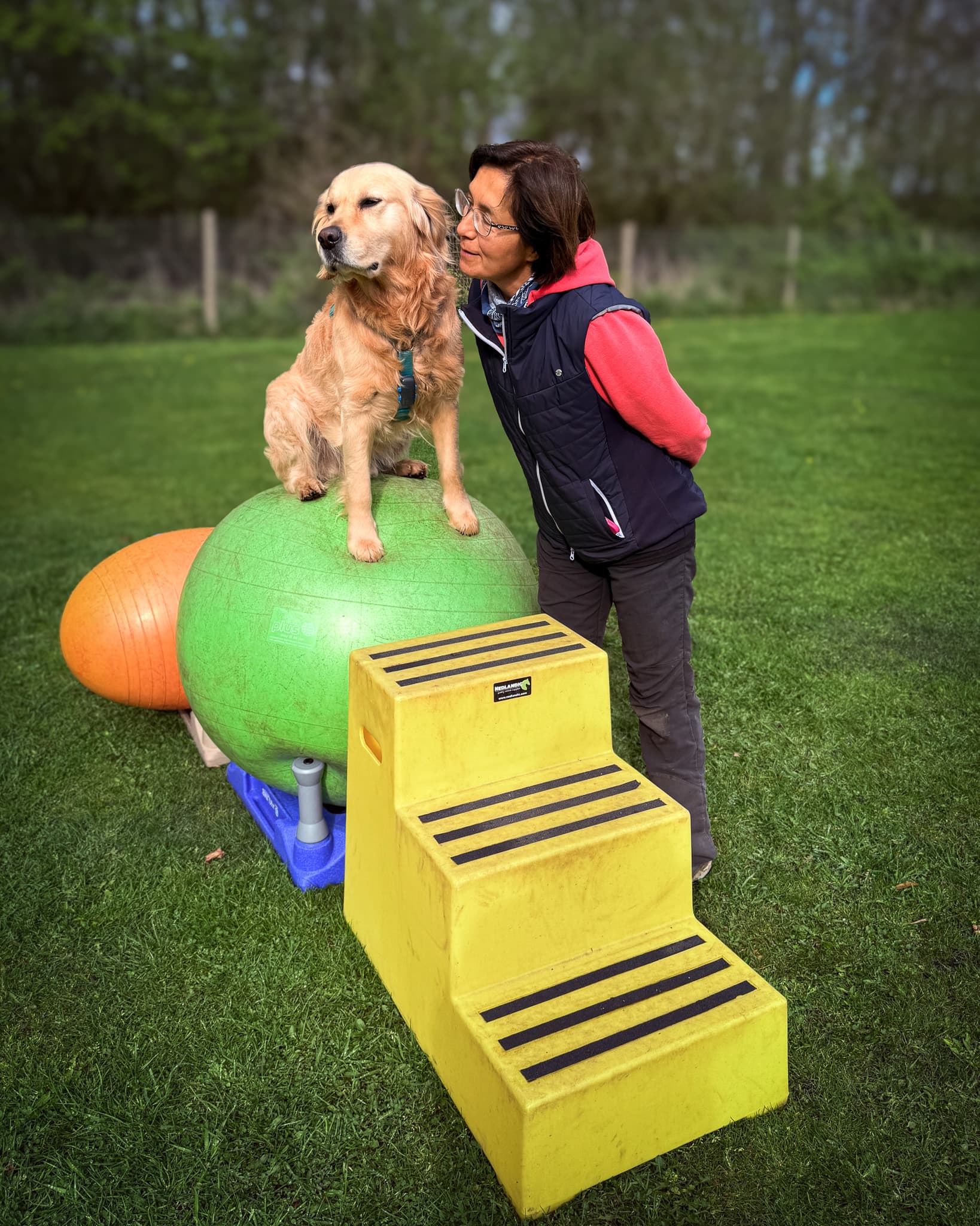Veronica with a golden retriever at her training field
